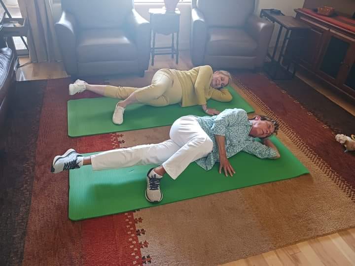 Two Pure Body Strength clients doing mobility exercises